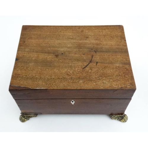 804 - A 19thC mahogany fitted box with  pressed brass handles and feet and opening to reveal fitted sectio... 