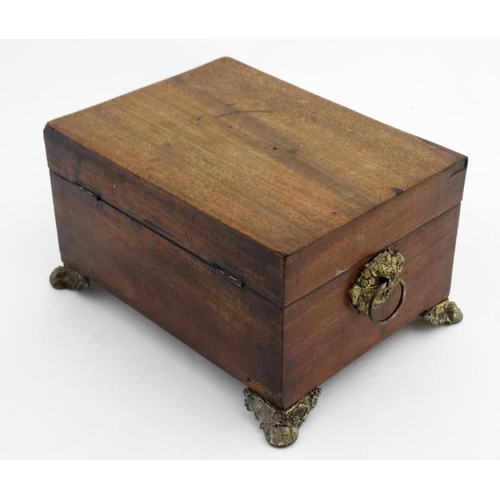 804 - A 19thC mahogany fitted box with  pressed brass handles and feet and opening to reveal fitted sectio... 