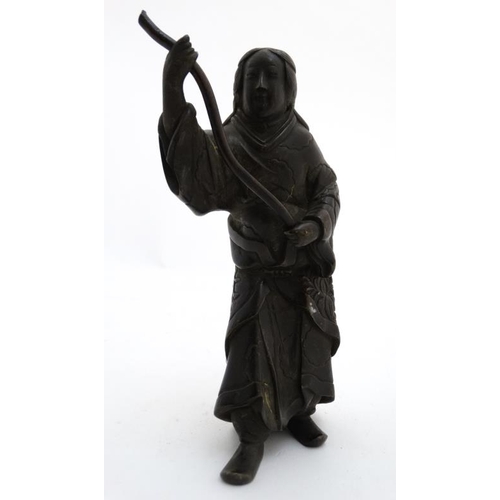 817 - An 18thC / 19thC cast and patinated Oriental bronze figure holding a removable staff. (was possibly ... 