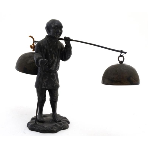 819 - A c.1900 Japanese spelter figure carrying 2 bells. approx 8 1/2'' high