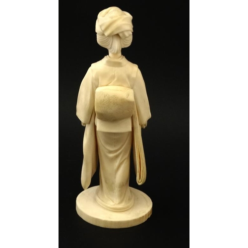 823 - A Japanese Ivory Meiji okimono of a female figure holding a fan 7 3/8'' high