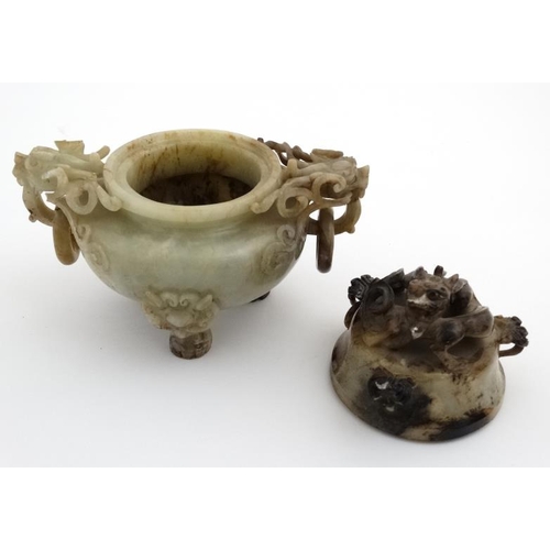 825 - A Jade three footed censor with dragon mask handles and lid with further dragon decoration. The whol... 