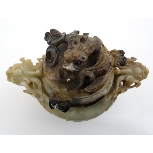 825 - A Jade three footed censor with dragon mask handles and lid with further dragon decoration. The whol... 