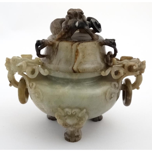 825 - A Jade three footed censor with dragon mask handles and lid with further dragon decoration. The whol... 