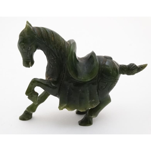 829 - A Chinese spinach green carving of a horse 3 1/8'' high x 4'' long