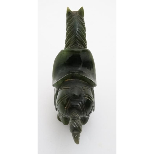 829 - A Chinese spinach green carving of a horse 3 1/8'' high x 4'' long