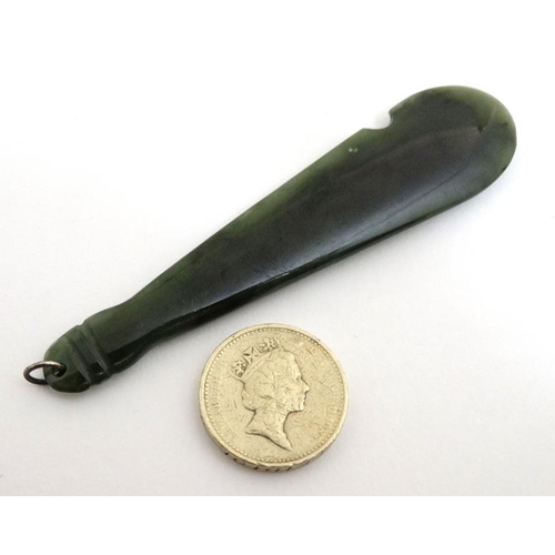 833 - An Oriental green jade pendant in the form of a club 3 1/2'' long