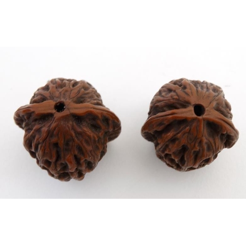 836 - 2 Japanese large ojimie beads in the form of a carved walnuts with central hole. Largest approx 1'' ... 