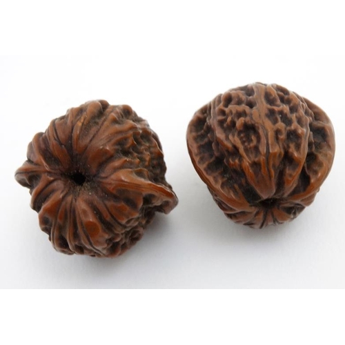 836 - 2 Japanese large ojimie beads in the form of a carved walnuts with central hole. Largest approx 1'' ... 