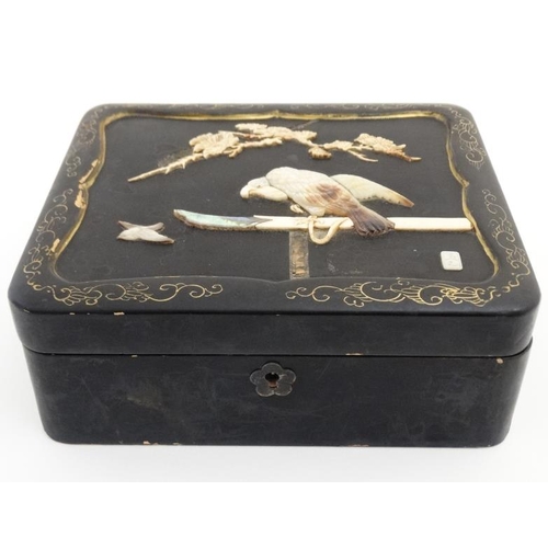 841 - An early 20thC lacquered hinged lidded cabinet with mother of pearl ivory and abalone depicting an e... 