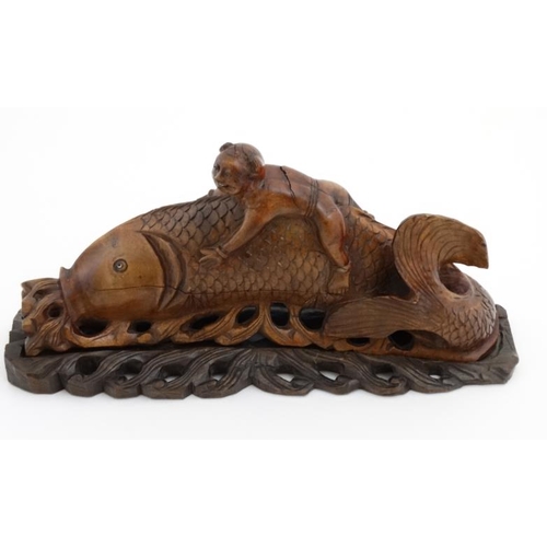 844 - A Chinese mythological carving depicting a figure upon the back of a large fish 13'' long