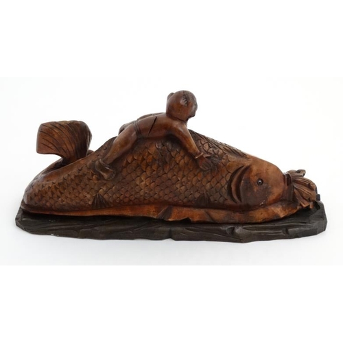 844 - A Chinese mythological carving depicting a figure upon the back of a large fish 13'' long