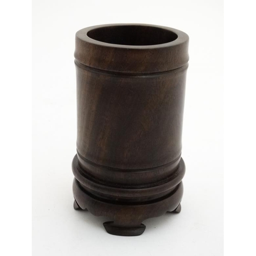 845 - A Chinese cylindrical zitan wood brush pot with integral four foot stand.  5 1/2'' high x 3 1/4'' di... 