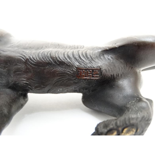 855 - A Japanese Meji period bronze sculpture , model of a striped tiger with glass eyes, signed under. 9 ... 