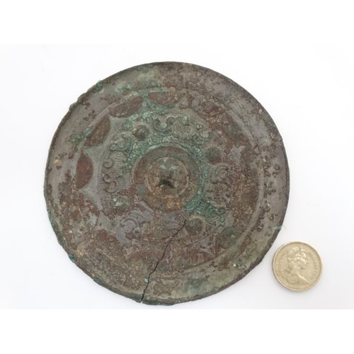 859 - Oriental:  Chinese Bronze Mirror : a disc shaped mirror ( now with signs of verdigris ) having relie... 