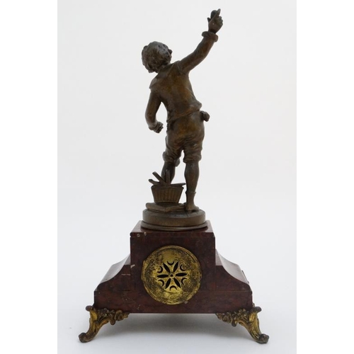 86 - French Clock : a red marble cased mantle clock  with ormolou mounts surmounted by a spelter figure e... 