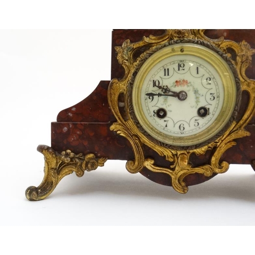 86 - French Clock : a red marble cased mantle clock  with ormolou mounts surmounted by a spelter figure e... 