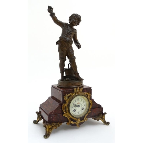 86 - French Clock : a red marble cased mantle clock  with ormolou mounts surmounted by a spelter figure e... 