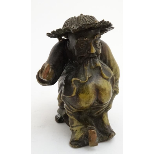 861 - A cast bronze hollow figure of an elder reprimanding a young boy with a shoe. 7'' x 7''