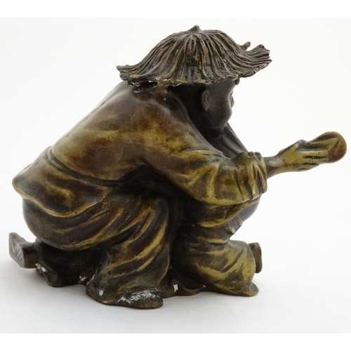 861 - A cast bronze hollow figure of an elder reprimanding a young boy with a shoe. 7'' x 7''