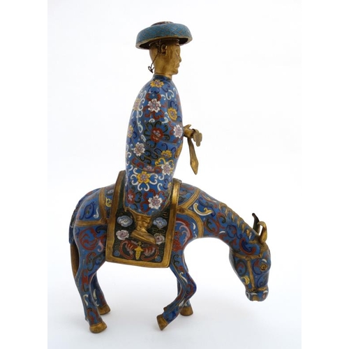 871 - A Chinese gilt and Cloisonne censer formed as a figure on horseback wearing a hat and  holding a sha... 