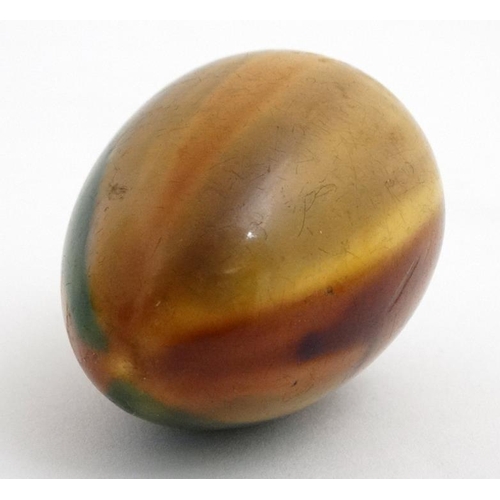 893 - A treen egg with Ruskin style glazes 3 1/8'' long