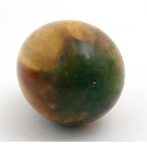 893 - A treen egg with Ruskin style glazes 3 1/8'' long