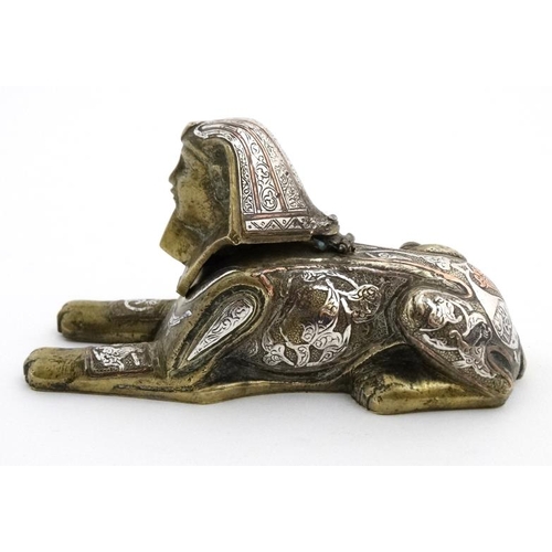 896 - A Victorian desk top inkwell in the form of a sphinx profusely inlaid with copper and silver to the ... 