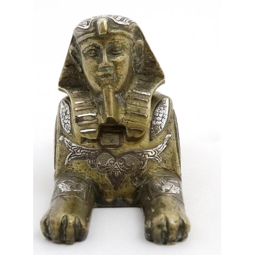 896 - A Victorian desk top inkwell in the form of a sphinx profusely inlaid with copper and silver to the ... 