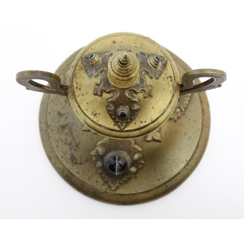 904 - A 19thC brass inkstand with trophy cup style inkwell on circular base and set with 6 banded agate ca... 