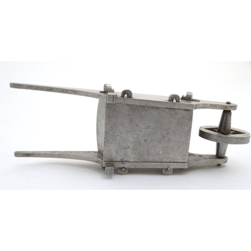 927 - An aluminum model of a garden wheelbarrow with peg joints. 7 1/4'' long