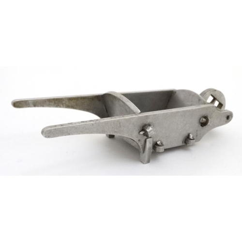 927 - An aluminum model of a garden wheelbarrow with peg joints. 7 1/4'' long