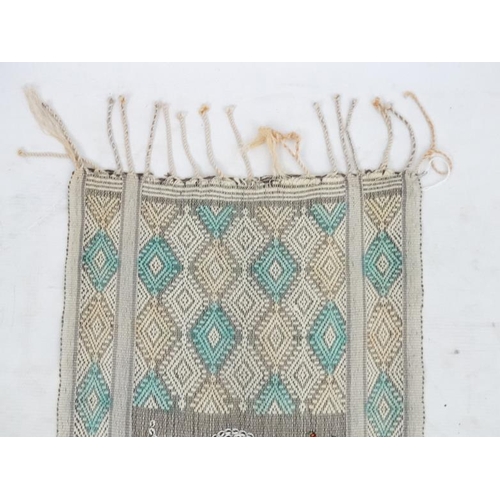 937 - A cotton table runner with pale yellow and green diamond design on a cream ground, having two panels... 