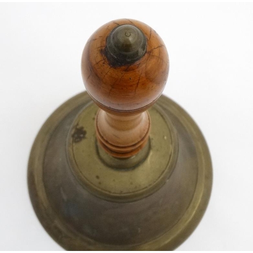 939 - A large handbell with turned fruit wood handle, the whole standing 14 1/2'' high