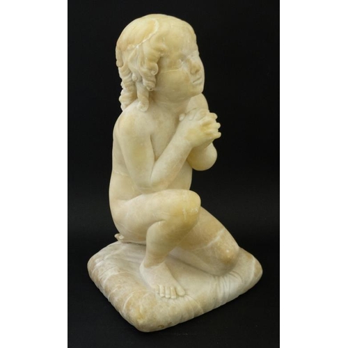 942 - A c.1900 white marble figure of a boy preying on one knee resting upon a squared cushion 14 1/2'' hi... 