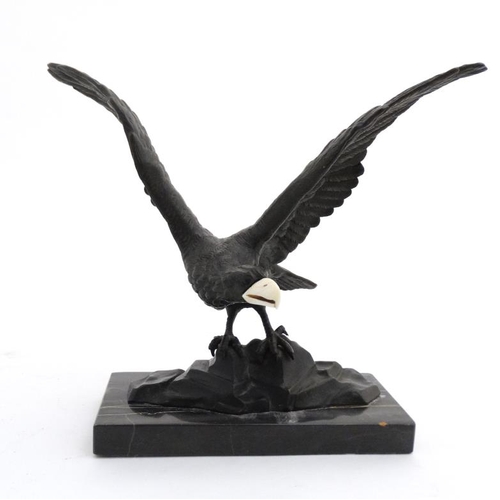 951 - An Art Deco elephantine cast bronze of an eagle with ivory beak mounted upon a marble base. 9 1/4'' ... 