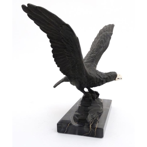 951 - An Art Deco elephantine cast bronze of an eagle with ivory beak mounted upon a marble base. 9 1/4'' ... 