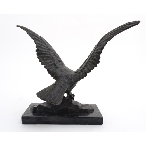 951 - An Art Deco elephantine cast bronze of an eagle with ivory beak mounted upon a marble base. 9 1/4'' ... 