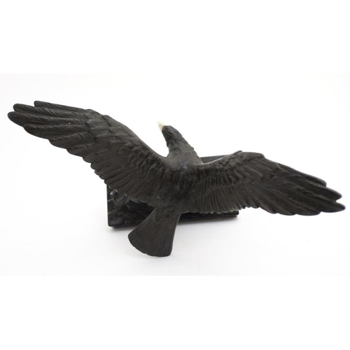 951 - An Art Deco elephantine cast bronze of an eagle with ivory beak mounted upon a marble base. 9 1/4'' ... 