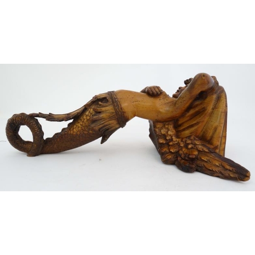 963 - A 19thC carved pine figurehead / caryatid wall bracket in the form of a winged mermaid with acanthus... 