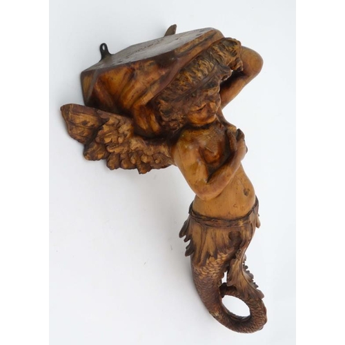 963 - A 19thC carved pine figurehead / caryatid wall bracket in the form of a winged mermaid with acanthus... 