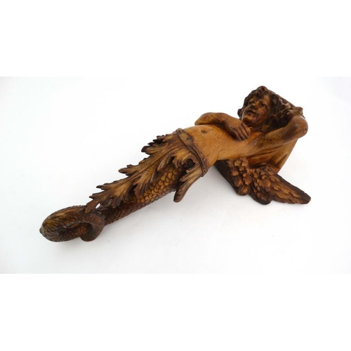 963 - A 19thC carved pine figurehead / caryatid wall bracket in the form of a winged mermaid with acanthus... 