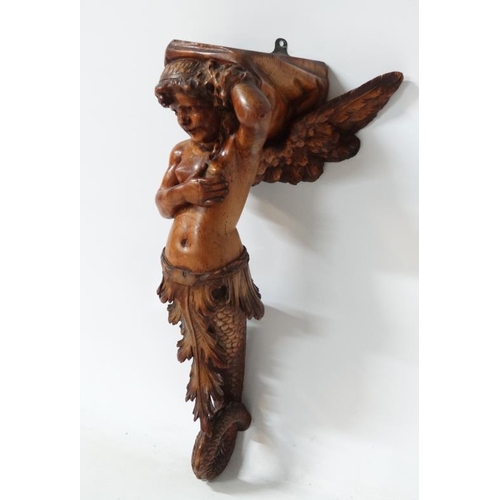 963 - A 19thC carved pine figurehead / caryatid wall bracket in the form of a winged mermaid with acanthus... 