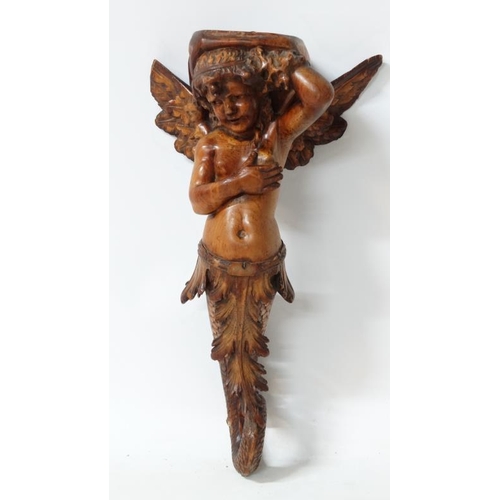 963 - A 19thC carved pine figurehead / caryatid wall bracket in the form of a winged mermaid with acanthus... 