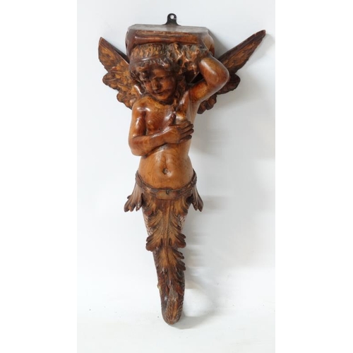 963 - A 19thC carved pine figurehead / caryatid wall bracket in the form of a winged mermaid with acanthus... 