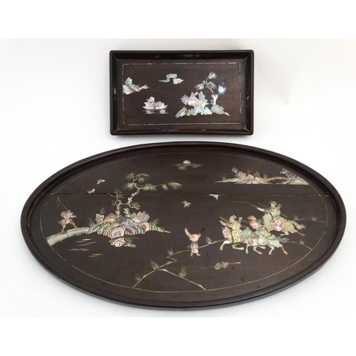 972 - A Chinese native hardwood oval tray depicting abalone and mother of pearl inlay together with a smal... 