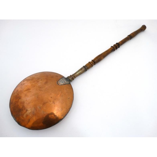 976 - A 19thC brass and copper hot water bed warming pan with turned wooden handle unscrewing. The whole 4... 