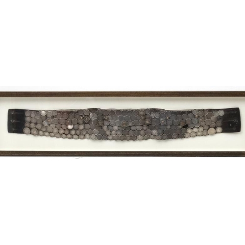 980 - A South American Gaucho belt - A leather belt with pockets and decorated with a quantity of South Am... 