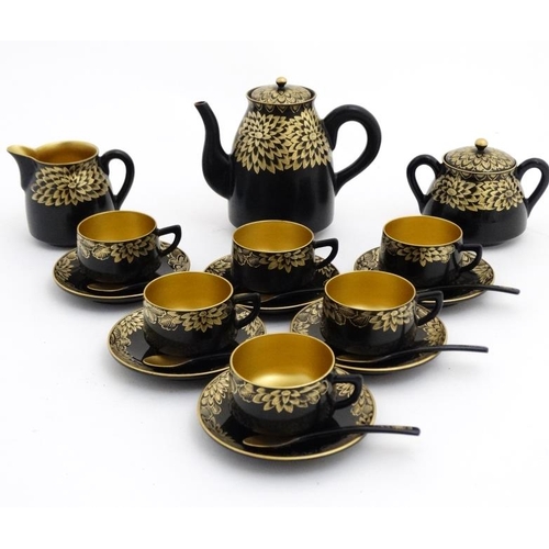 981 - A Japanese gilt and lacquer decorated teaset comprising teapot 6 cups, saucers, sucrier, milk pot, t... 