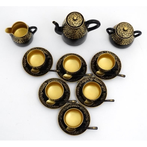 981 - A Japanese gilt and lacquer decorated teaset comprising teapot 6 cups, saucers, sucrier, milk pot, t... 